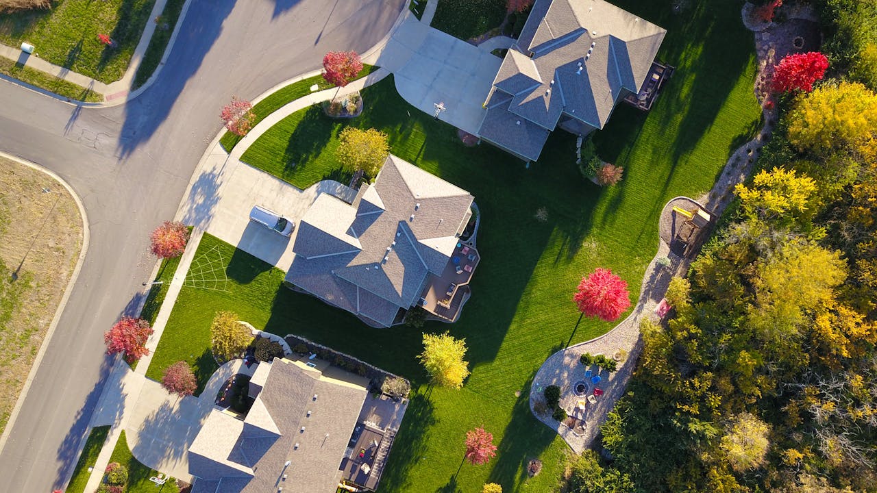 The Art of Drawing Readers In: Your attractive post title goes here A picturesque aerial view showcasing suburban homes with vibrant gardens and tree-lined streets.